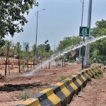 CDA staffers showing water on plants at roadside greenbelt in Federal Capital