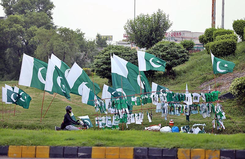 Vendors displaying National flags along Islamabad Expressway to attract the customers as the nation starts preparations to celebrate Independence Day in befitting manners