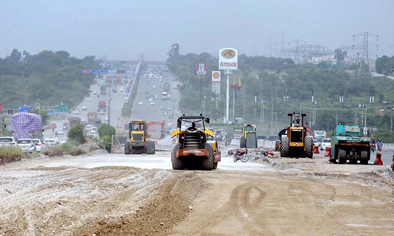 Heavy machinery being used to construct new lanes on Islamabad Expressway for smooth traffic flow