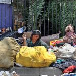 A woman busy in sorting out recycling items at Commercial Market