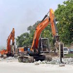 Heavy machinery being used for repairing the Islamabad Expressway during repairing work in Federal Capital