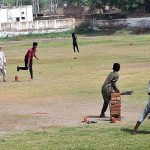 A group of youngsters playing cricket at Railway Ground.