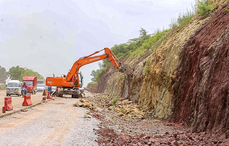 Heavy machinery being used for repairing the Islamabad Expressway during repairing work in Federal Capital