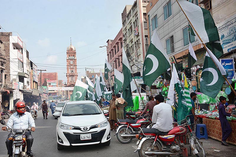 Vendor displaying National flags to attract the customers as the nation starts preparations to celebrate Independence Day in befitting manners at roadside
