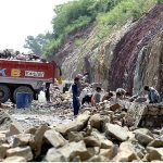 Labouers busy in building a boundary wall on Islamabad Expressway
