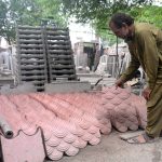 A worker busy in arranging cement tiles after preparing at his workplace