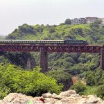 A beautiful view of train passing on a bridge near Expressway in the Federal Capital