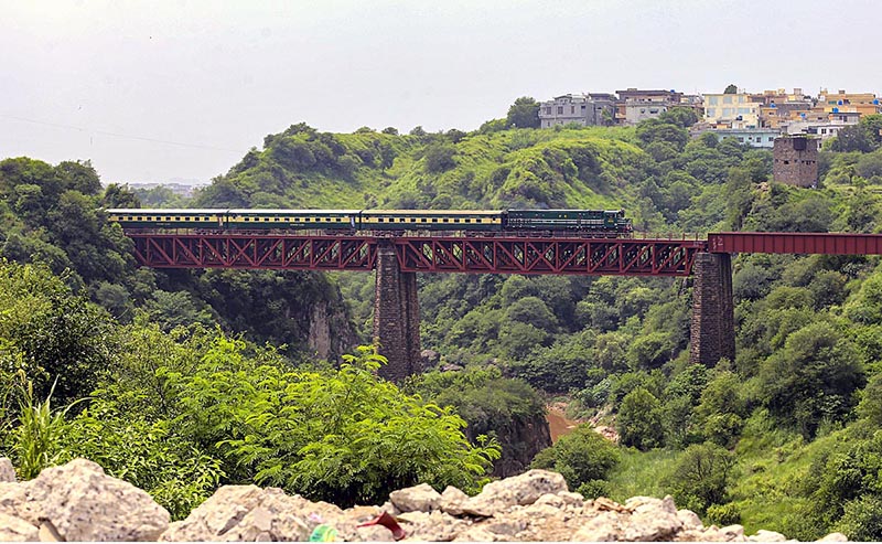 A beautiful view of train passing on a bridge near Expressway in the Federal Capital