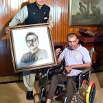 President Dr Arif Alvi receiving his portrait made by Mr Umer Jarral, an artist with cerebral palsy, at Aiwan-e-Sadr