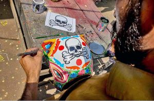 A painter busy in paint the part of truck at his workplace at Pirwadahi