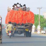 People traveling on the rooftop of a loaded truck may cause any life risk and show the negligence of concerned authorities at Kabirwala Road