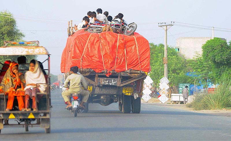 People traveling on the rooftop of a loaded truck may cause any life risk and show the negligence of concerned authorities at Kabirwala Road