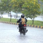 A motorcyclist on the way during rain that experienced the Federal Capital