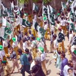 Students of Government high school participating with national flags in a Geo Pakistan rally in connection with Pakistan Independence day celebrations outside Press Club road