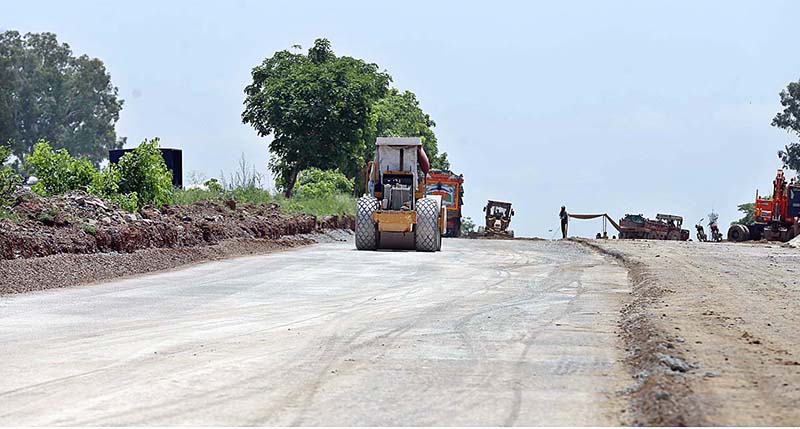 Labouers busy in building a boundary wall on Islamabad Expressway