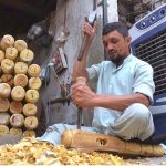 A carpenter busy in making part of a traditional bed (charpai) at his workplace in Dabgari area