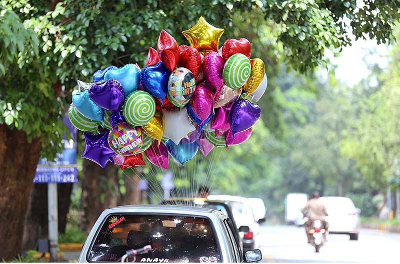 A vendor selling colorful balloons to attract customers at F6 area in the Federal Capital