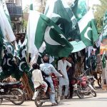 Vendor displaying National flags and other stuff to attract the customer in preparation for the Independence Day