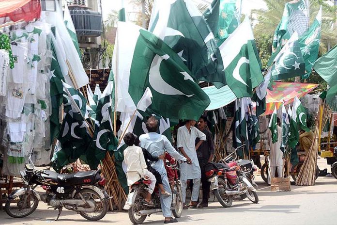 Vendor displaying National flags and other stuff to attract the customer in preparation for the Independence Day