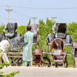 Vendors busy in displaying plastic chairs to attract customers outside Fruit and Vegetable market