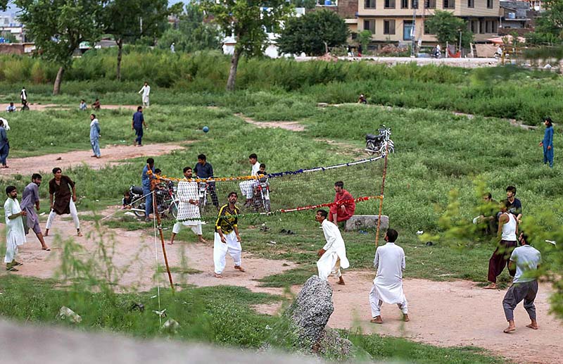 A group of youngsters playing volleyball at roadside greenbelt in Federal Capital