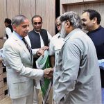 Prime Minister Muhammad Shehbaz Sharif distributing health insurance cards among the working journalists, media workers, artists and technical resource workers
