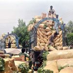 Labourers busy unloading vegetables on the delivery truck at the vegetable Market