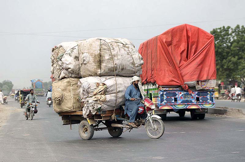 An overloaded tricycle holder coming wrong side of the busy bypass road may cause a mishap