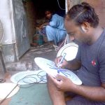 A skilled worker reparing parts of traditional drum (Dhool) at his workplace