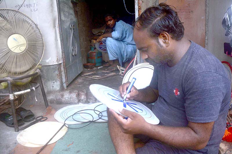 A skilled worker reparing parts of traditional drum (Dhool) at his workplace