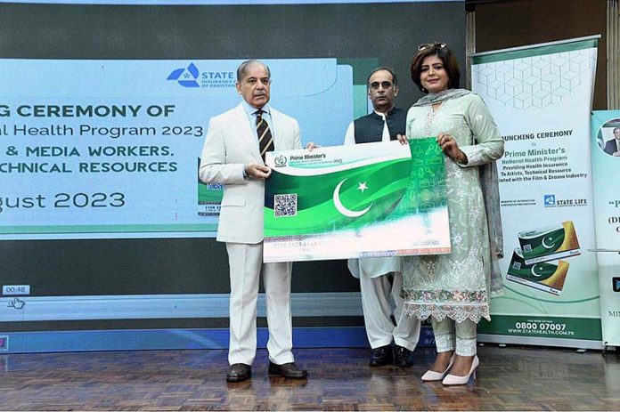 Prime Minister Muhammad Shehbaz Sharif distributing health insurance cards among the working journalists, media workers, artists and technical resource workers