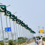 A beautiful view of national flags waving on the electric poles at Qasimabad