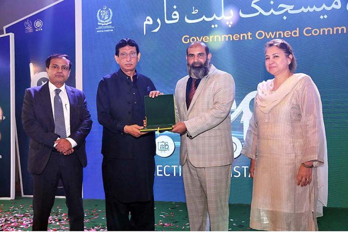 Federal Minister for IT and Telecommunication Syed Amin Ul Haque giving away shield to participant at launching ceremony of Pakistan's First Communication APP “beep''