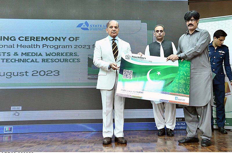 Prime Minister Muhammad Shehbaz Sharif distributing health insurance cards among the working journalists, media workers, artists and technical resource workers
