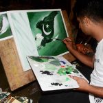 An artist busy in giving final touch on the painting for independence day at NCA