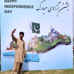 A man taking selfie with Pakistan Map model during Independence Day in the Federal Capital