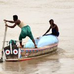 Fisherman busy in fishing on the boat at Indus River