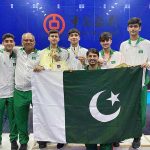Squash players and coach in a group photograph with Pakistani Flag after winning Asian Junior Individual Squash Championship