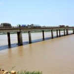 A view of heavy vehicles passing through the bridge on the Indus River at bypass area