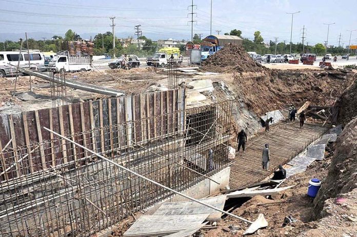 Labourers busy in construction work of IJP Road during development work in the city Labourers busy in construction work of IJP Road during development work in the city