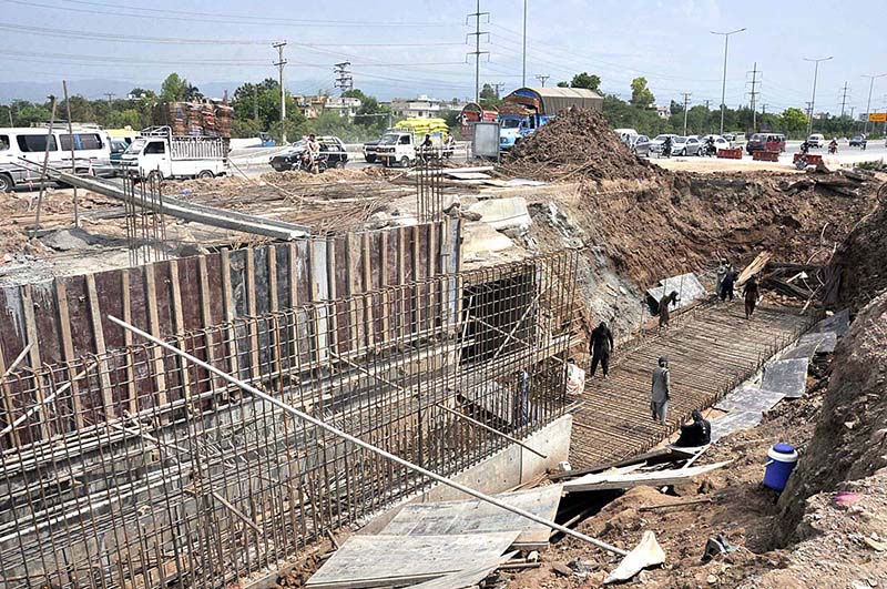 Labourers busy in construction work of IJP Road during development work in the city