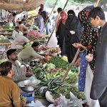 Women purchasing vegetables in Friday Bazaar at Shamsabad