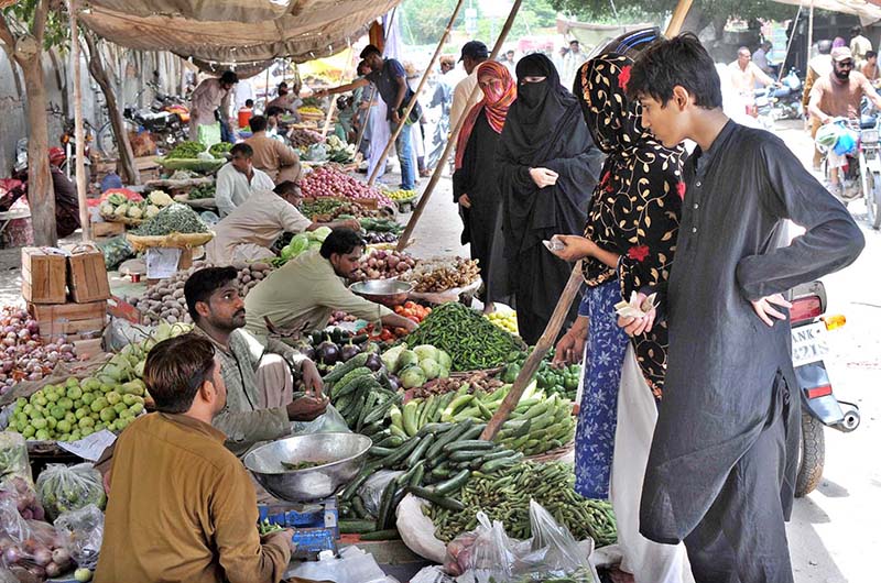 Women purchasing vegetables in Friday Bazaar at Shamsabad