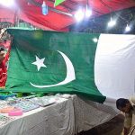 A vendor displaying national flag and other stuff to attract the customers in connection with upcoming Independence Day celebrations