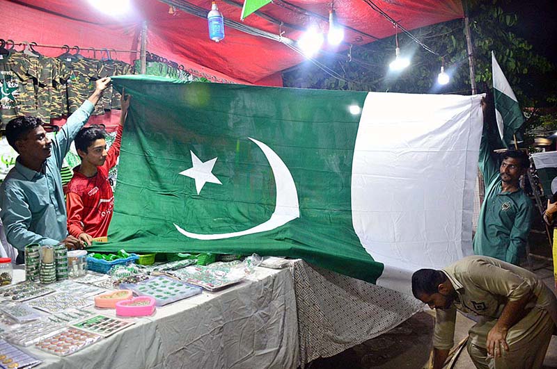 A vendor displaying national flag and other stuff to attract the customers in connection with upcoming Independence Day celebrations