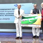 Prime Minister Muhammad Shehbaz Sharif distributing health insurance cards among the working journalists, media workers, artists and technical resource workers