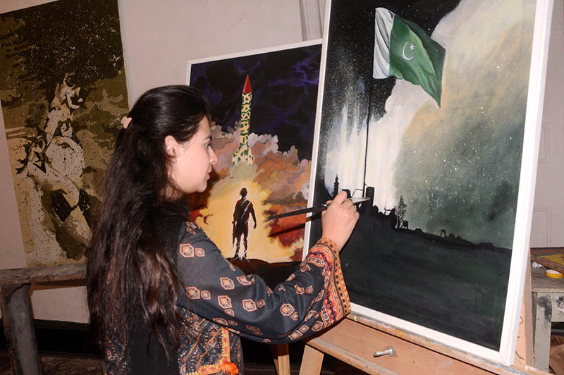 An artist busy in giving final touch on the painting for independence day at NCA