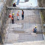 A view of ongoing construction work of Red Line Bus Service named as (Peoples Bus Service) at University Road in Provincial Capital