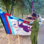 Workers busy in painting on boat at bank of River Chenab