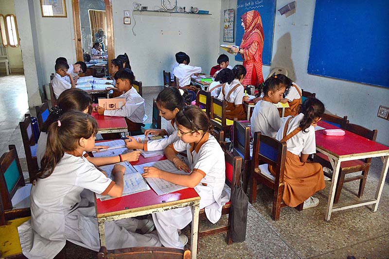 Students arrive to attend school on the opening day after two month Summer Vacation at Latifabad